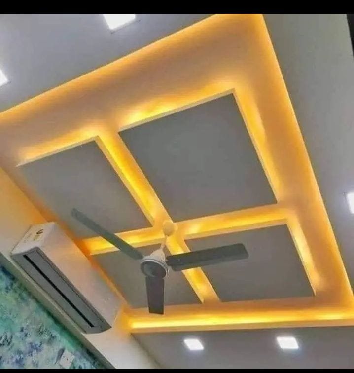 Grey square tray ceiling with warm cove lighting and a fan