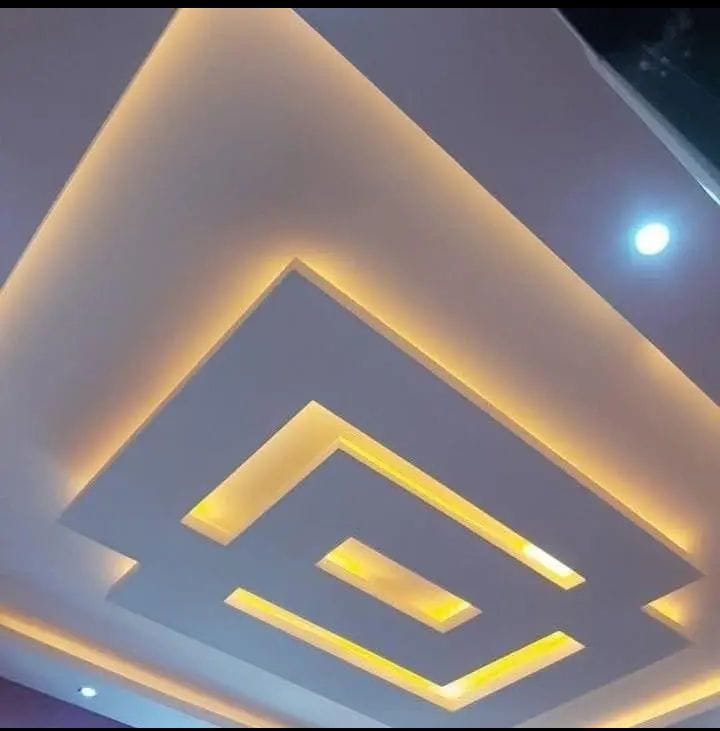 White geometric tray ceiling with warm cove lighting