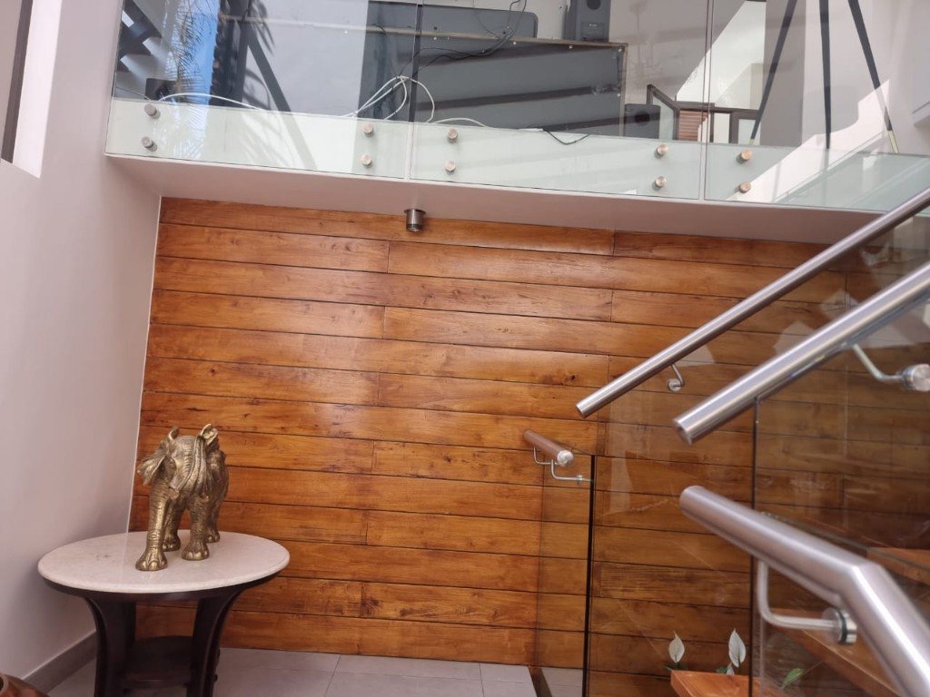 Horizontal timber cladding beside glass-balustrade stairs