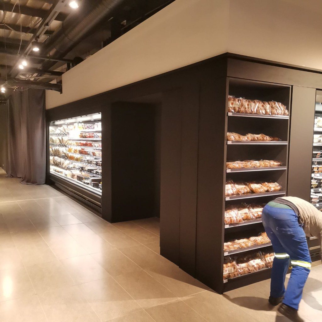 Black bakery joinery wrapping a refrigerated display