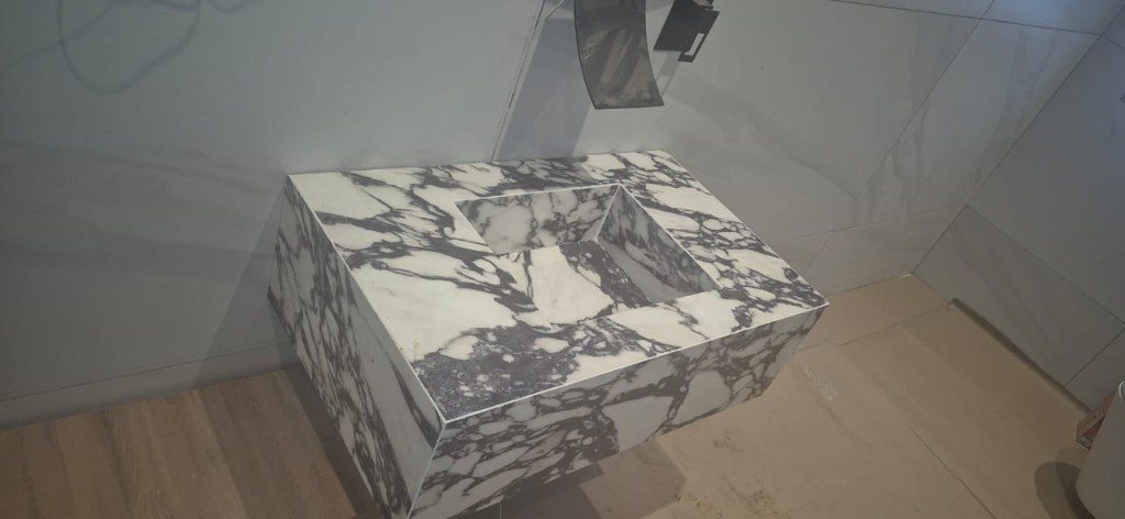 Floating marble vanity with an integrated trough basin
